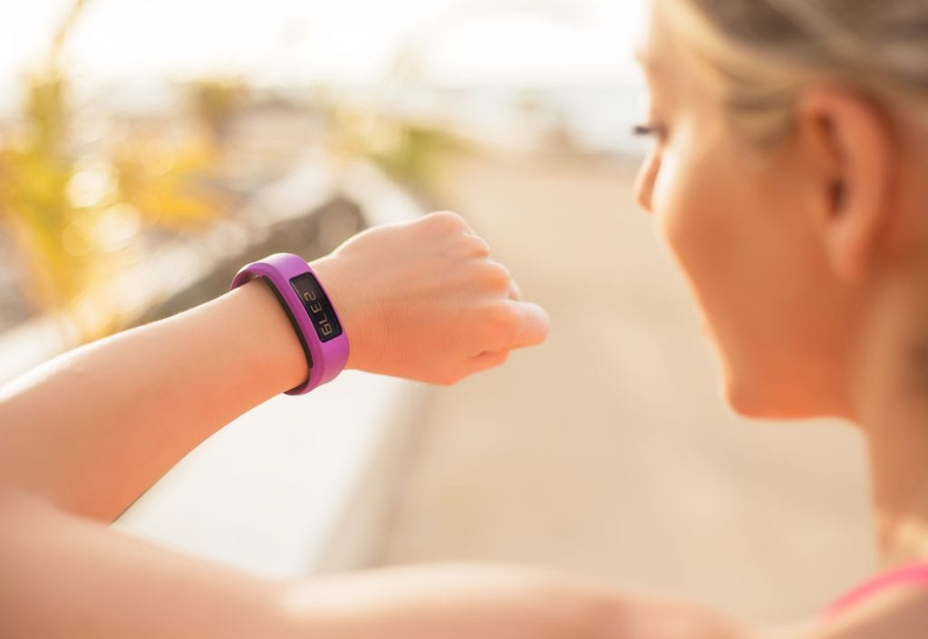 Woman looking at wearable fitness device