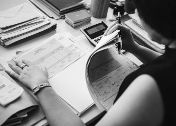 Asian woman working through paperwork