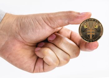 male hand holding e-RMB coin on isolated white background with space copy, china virtual money concept.